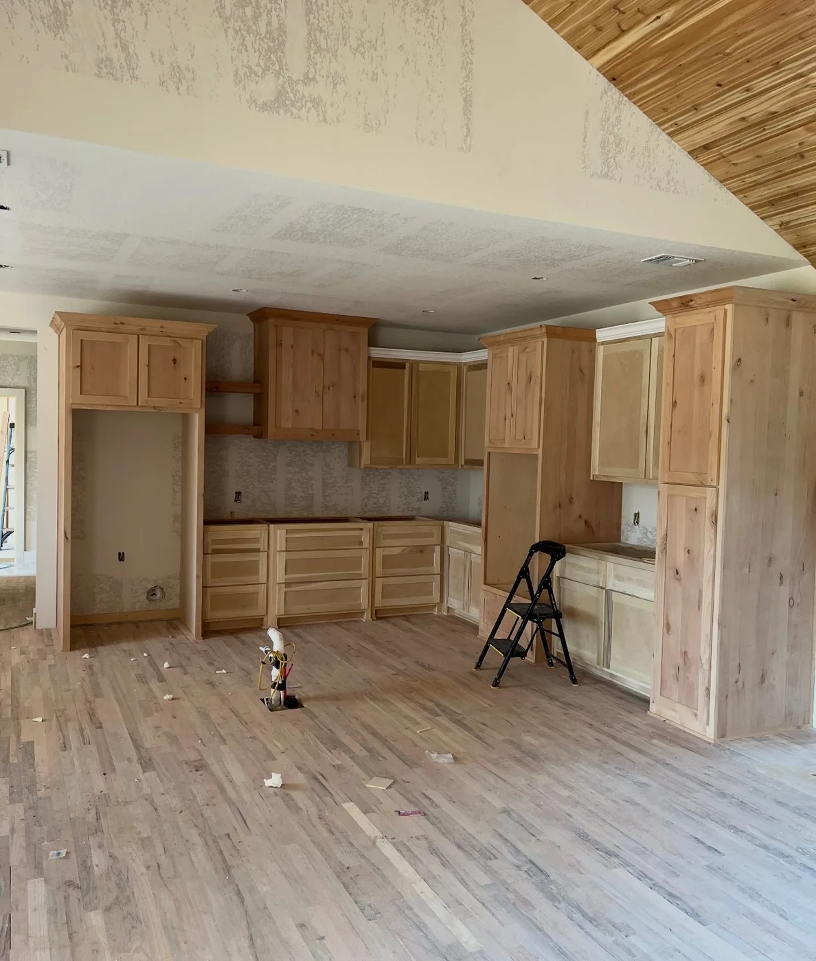 Perimeter kitchen cabinets with tall storage and upper cabinet runs