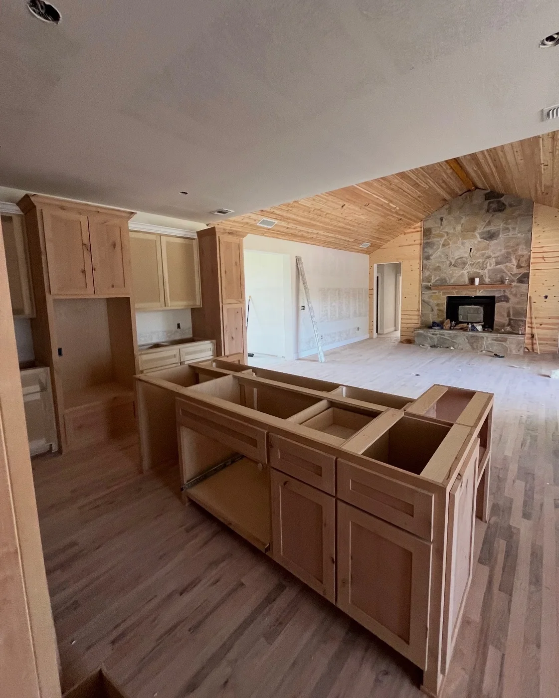 Open-plan kitchen cabinetry and central island during installation