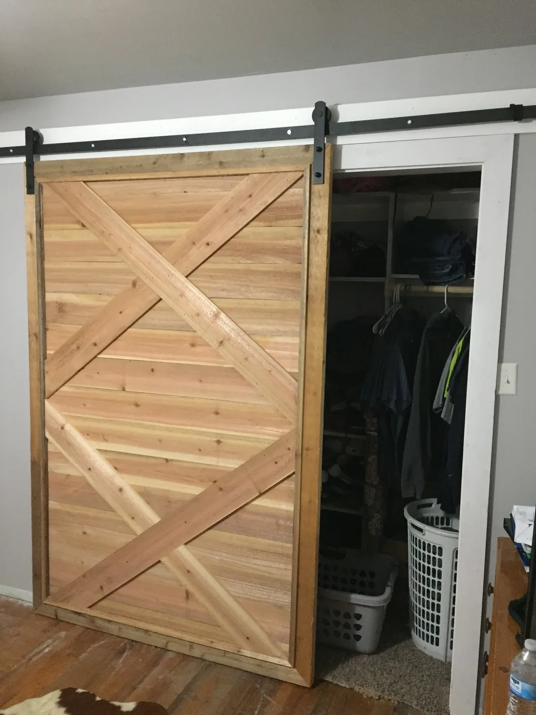 Custom wood barn door mounted on a sliding track